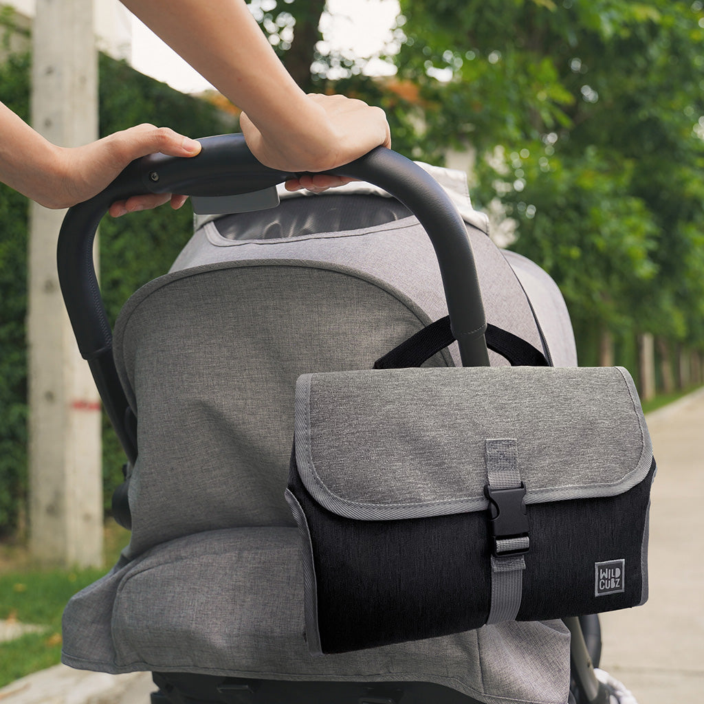 Lightweight, portable diaper changing pad with velcro handles for stroller and more